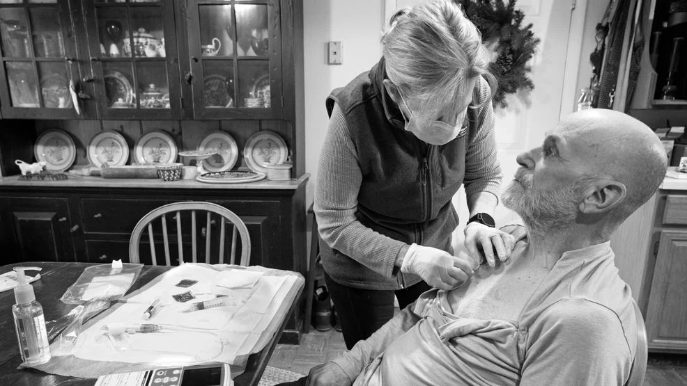 Douglas Graham documents his cancer journey with the help of reporter Tim Farmer and LoudounNow. In this picture his wife Dawn is helping him with his dock. (Photo by Douglas Graham)
