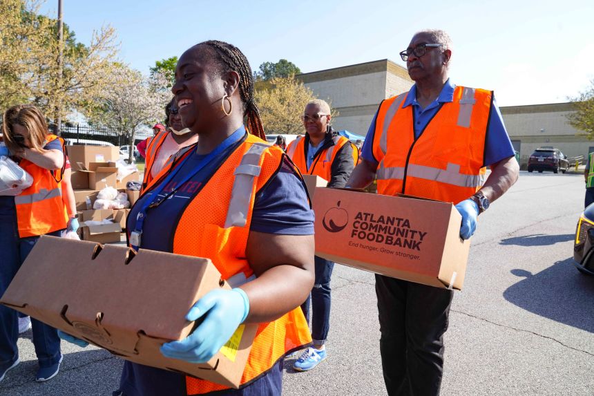 Atlanta Community Food Bank volunteers help distribute food for TSA agents Friday in Atlanta.