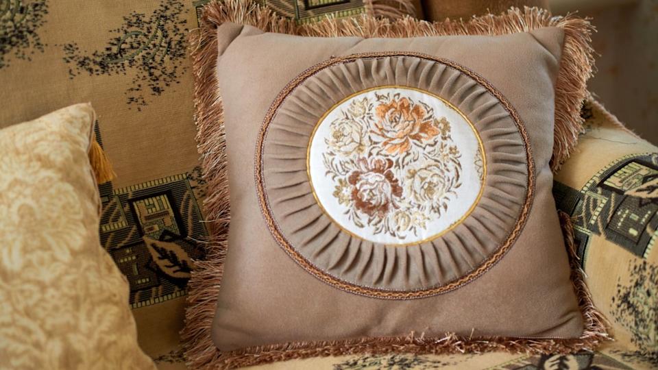 Decorative cushion with fringe and decorative panel depicting roses