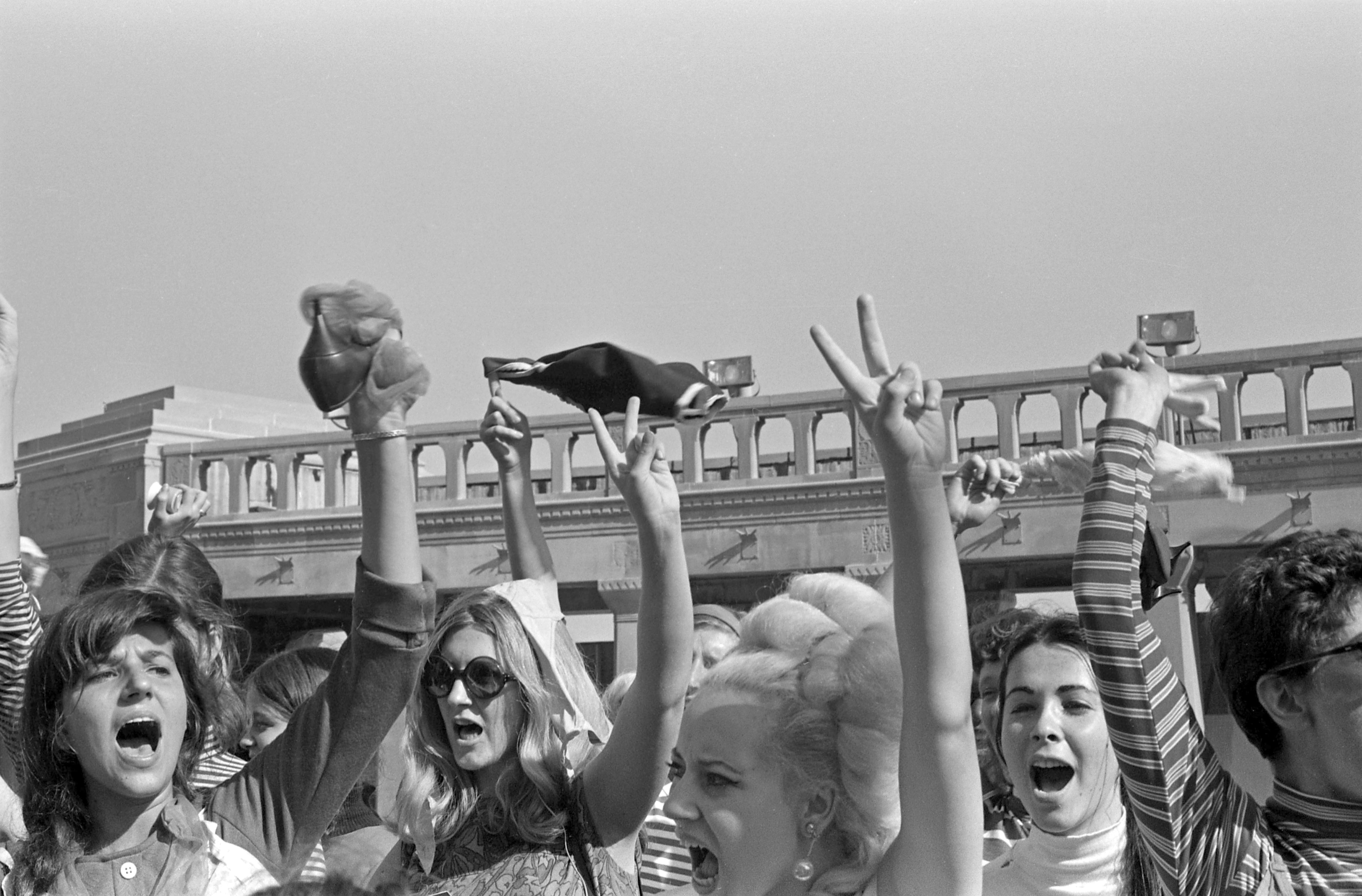 On the Atlantic City Boardwalk, protesters, some waving high heels or underwear, protest the Miss America pageant, Atlantic City, New Jersey, September 7, 1968. The protest, organized by the group New York Radical Women, was known as 'No More Miss America,' after a leaflet written and distributed by the group. (Photo by Bev Grant/Getty Images)