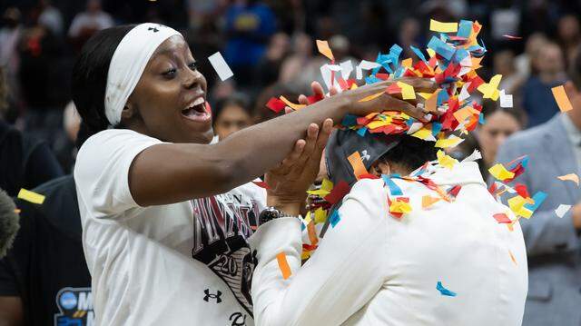 South Carolina Gamecocks guard Raven Johnson (25) throws confetti at head coach Dawn Staley after her team beat the Texas Christian University Horned Frogs 78-52 during the NCAA Women's Basketball Tournament Sweet 16 at Golden 1 Center in Sacramento, Monday, March 30, 2026.