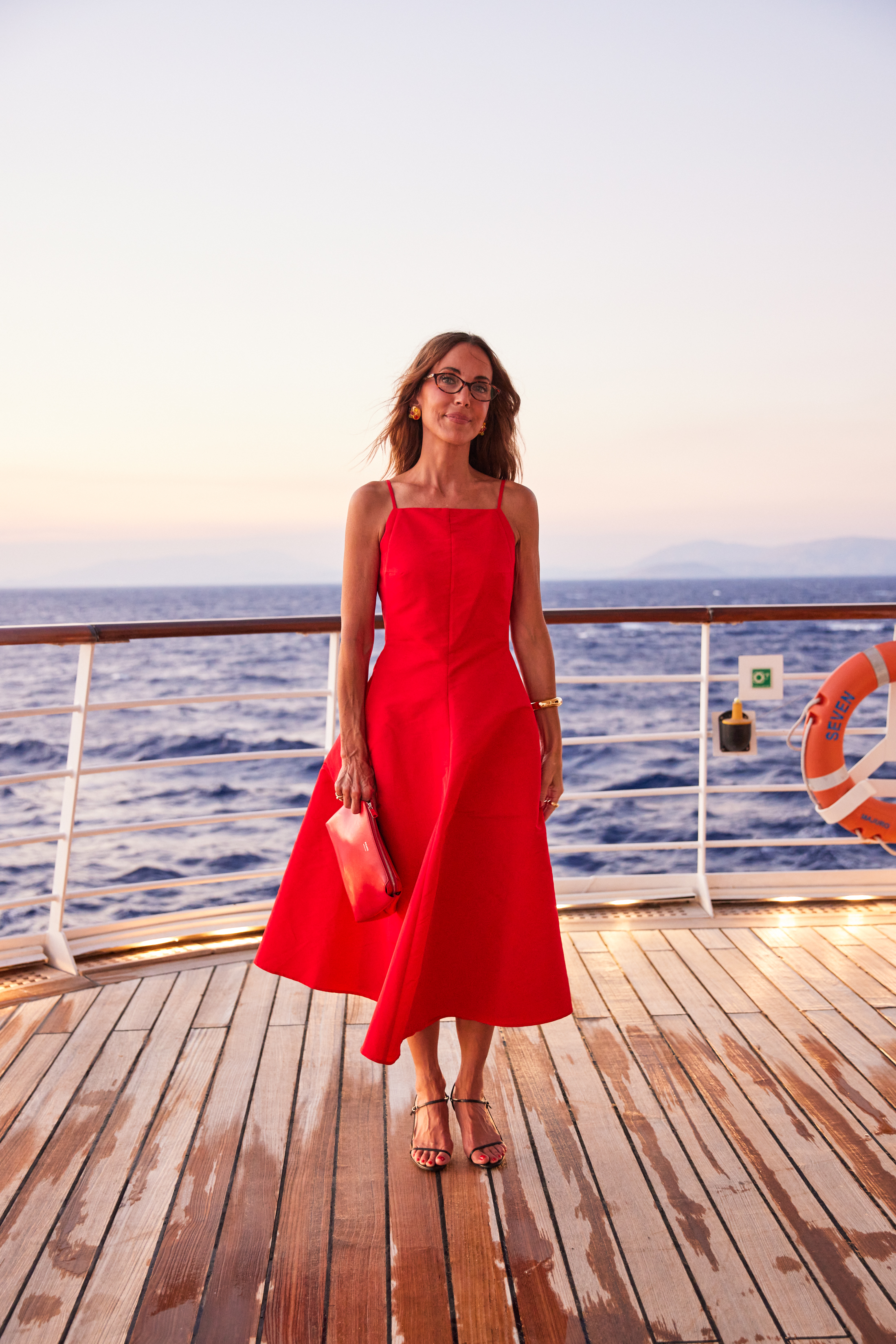 Larissa Mills is wearing a red waistcoat on a boat