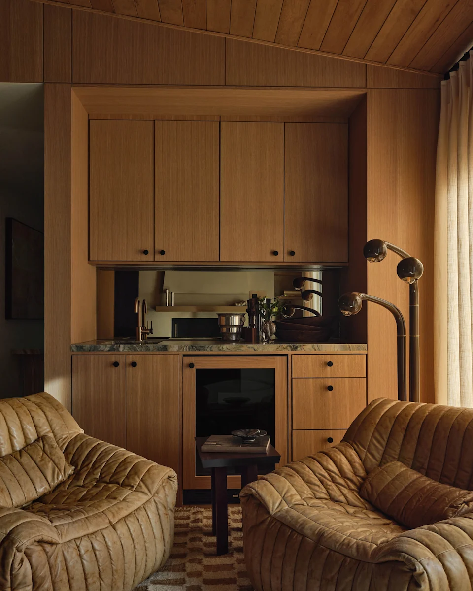 To add character to the Calabasas home, which was renovated before Reilly and Quittman bought it, Solis bought vintage pieces, like these 1970s Ligne Roset Cinna leather chairs from 1stDibs. The Galerie Solis Sol Ottoman is upholstered in Espresso Suede. The floor lamp is by Entler Studio.