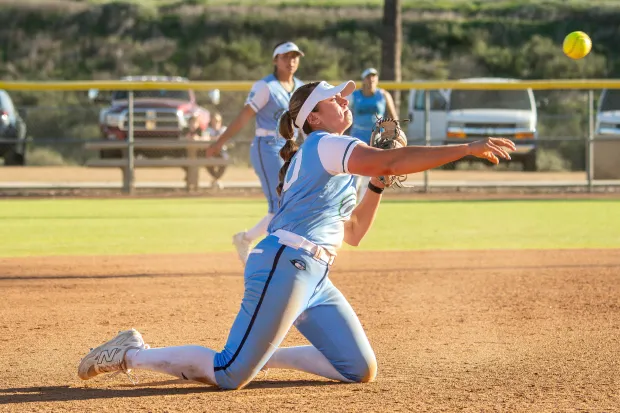 CSU Monterey Bay third baseman Nevaeh Martinez, a Soquel High alumna, crosses the diamond from her knees. (image mtb.fastpitch.)